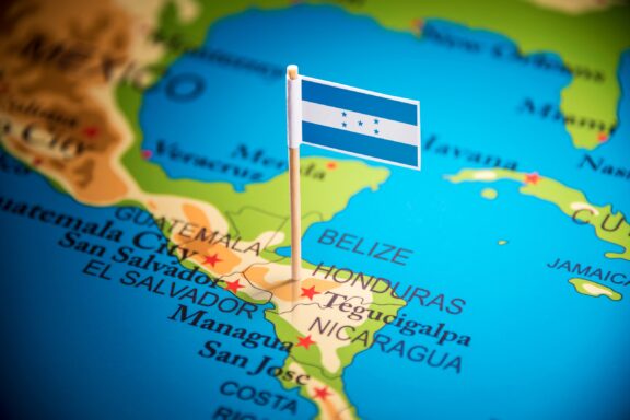 A pin with the flag of Honduras placed on Tegucigalpa on a map.