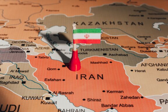 A pin with the flag of Iran placed on Tehran's location on a map.