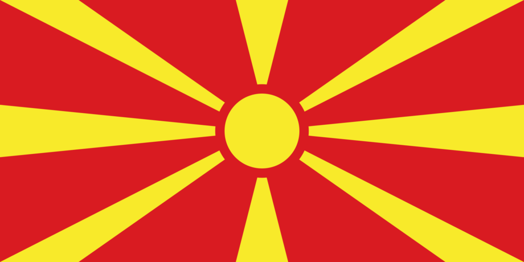 Flag of North Macedonia featuring a yellow sun with eight broadening rays extending to the edges of a red field.