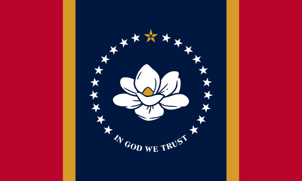 Mississippi state flag featuring a magnolia flower surrounded by stars with the phrase "In God We Trust" on a dark blue background, flanked by red vertical stripes.