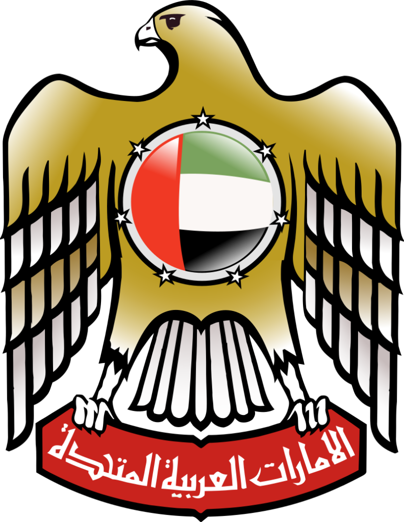 Coat of arms of the United Arab Emirates featuring a golden falcon with a red disk containing a dhow, flanked by seven stars above a red banner with Arabic script.