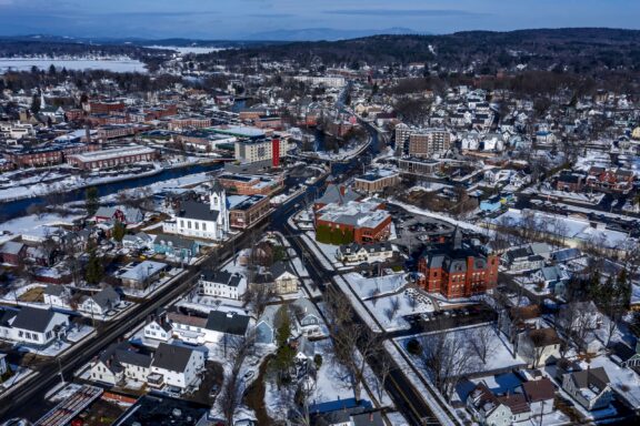 An aerial view of Laconia, New Hampshire with snow covering the ground.