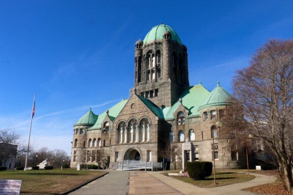 A low-angle view of the exterior of the Bristol County Superior Court in Massachusetts.