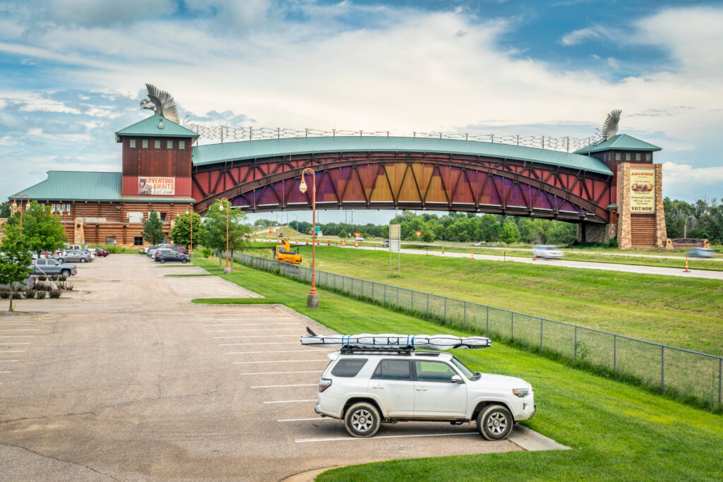 An SUV sits in a parking lot next to the Platte River and the Archway Monument in Kearney, Nebraska.