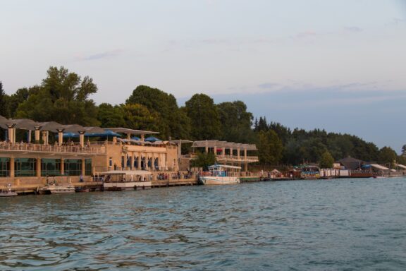 Buildings and boats line the edge of the Kura River in Central Aran, one of the economic regions of Azerbaijan.