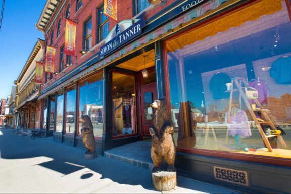 Bear sculptures stand in front of historic buildings in Lancaster, New Hampshire.