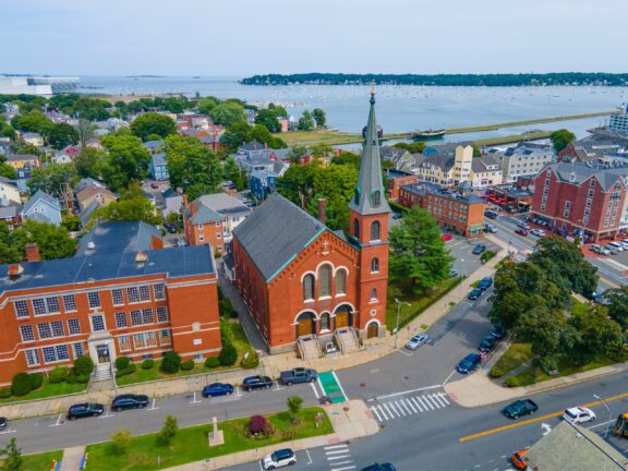 An aerial view of Salem, Massachusetts with water in the distance on a summer day.