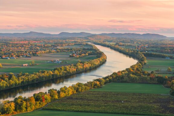 A view of the Connecticut River lined with trees from atop South Sugarloaf Mountain in Franklin County, Massachusetts.