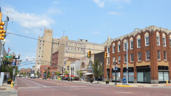 A street-level view of a street and buildings in downtown Flint, Michigan.