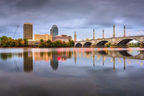 A view of downtown Springfield, Massachusetts and the Connecticut River at dusk.