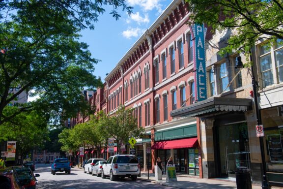 Cars and trees line the street in front of the Palace Theatre in downtown Manchester, New Hampshire.