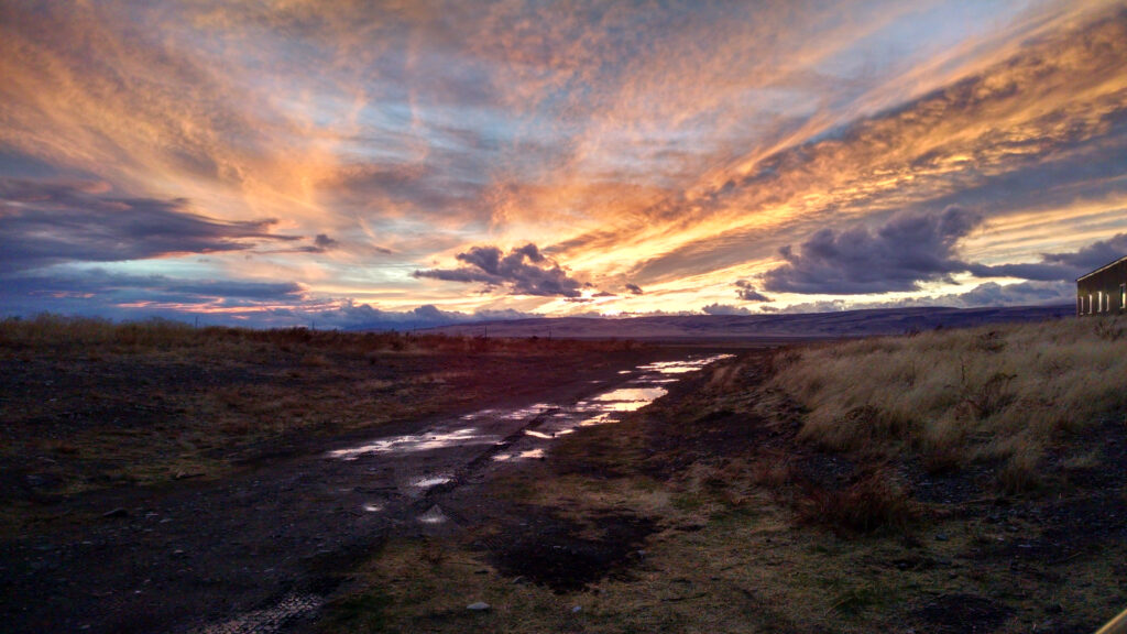 A partly cloudy sunset over grassy, rural Humboldt County in Nevada.