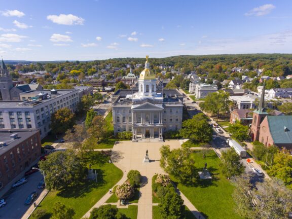 An aerial view of the New Hampshire State House on a sunny day.