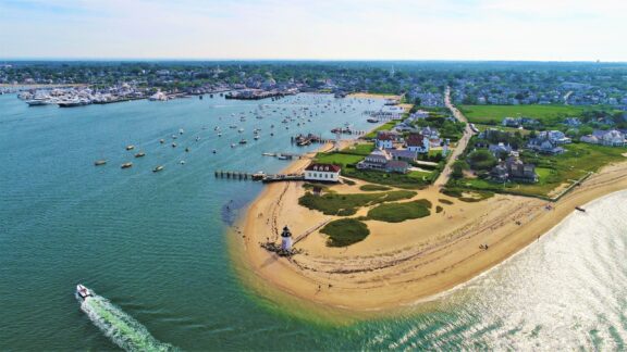 An aerial view of Brant Point and surrounding watercraft in Nantucket County, Massachusetts.