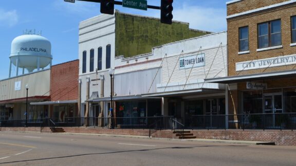 Building facades and a water tower line an empty street in Mississippi’s Neshoba County.