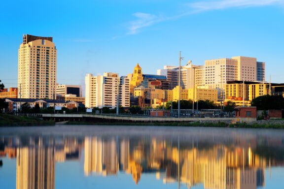 The Rochester, Minnesota skyline reflects in the water near dusk.