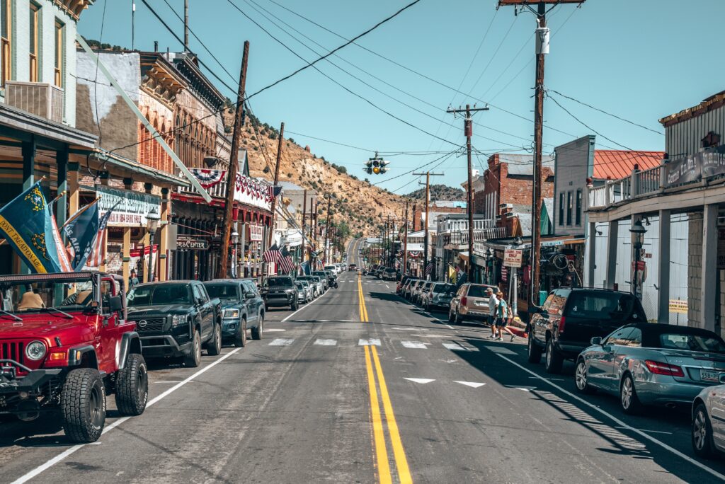 A street-level view of cars and storefronts lining the main street in Storey County’s Virginia City.