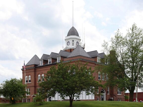 A low-angle view of the Worth County Courthouse on a cloudy day.