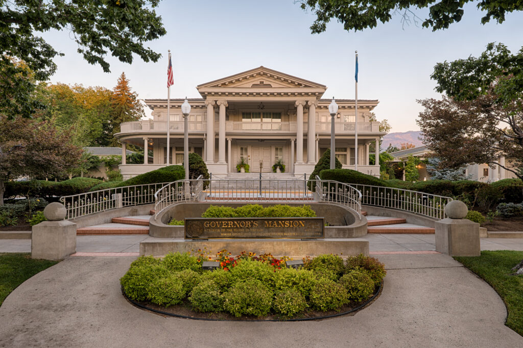 A ground-level view of the Governor’s Mansion façade in Carson City, Nevada.