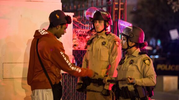 Young Man Interacting with Police Officers at Night Two police officers talk with a young man in Las vegas, Nevada at night.