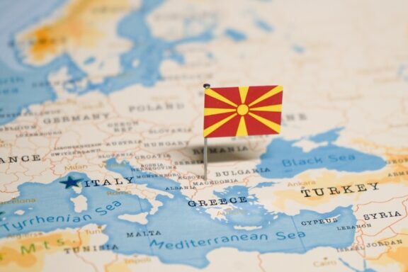 A Macedonian flag pin placed on Macedonia's location on a world map.