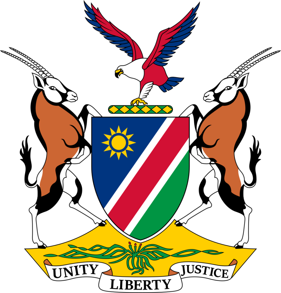 Coat of arms of Namibia featuring a shield with blue, white, green, and red stripes, an African fish eagle, two oryx, a Welwitschia plant, and a banner with the words "Unity, Liberty, Justice".