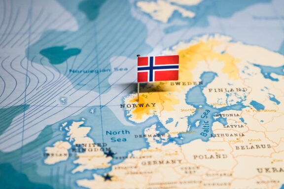 A map highlighting Norway's location with a Norwegian flag pin.