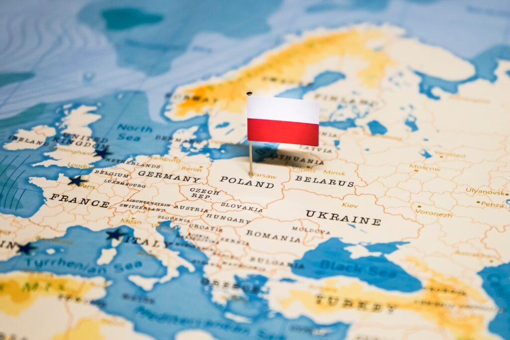 A Polish flag pin placed on Poland on a world map.