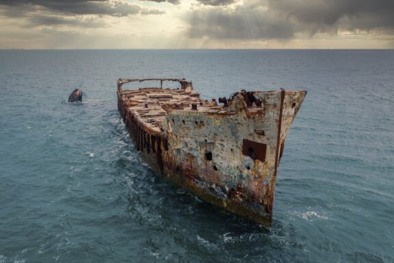 The infamous Sapona concrete ship sits wrecked in the shallow waters of the Caribbean Sea near the Bahamas.