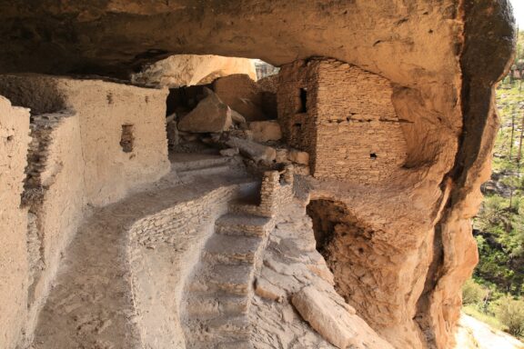 A view of ruins of stairs and dwellings carved out of the cliff in Catron County, New Mexico.