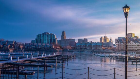 The Buffalo skyline rises behind the marina on a cloudy morning.