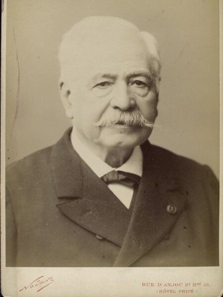 An aged, black-and-white portrait of Ferdinand de Lesseps. 