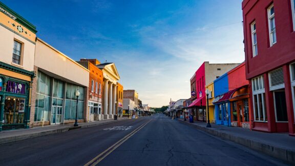 Colorful buildings line an empty downtown street in Silver City, New Mexico on an early morning.