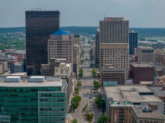 An aerial view of tall buildings lining a street in downtown Dayton, Ohio.