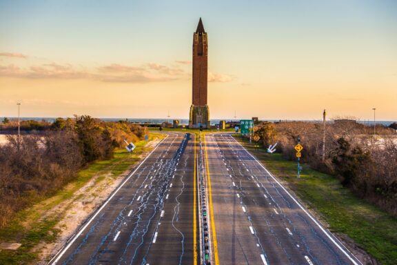 Two empty roads lead to the Jones Beach Water Tower during sunset on Long Island, New York.