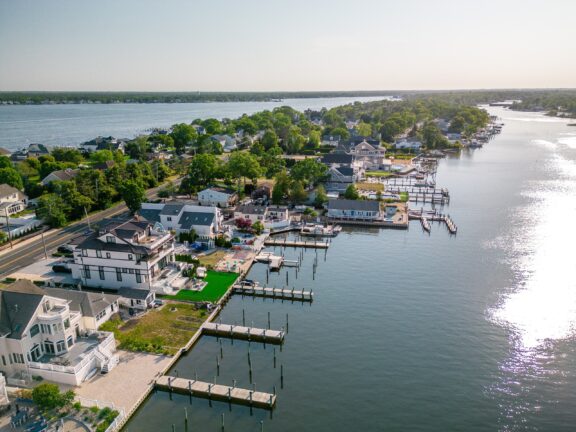 An aerial view of large houses with docks that connect to the water in Ocean County, New Jersey.
