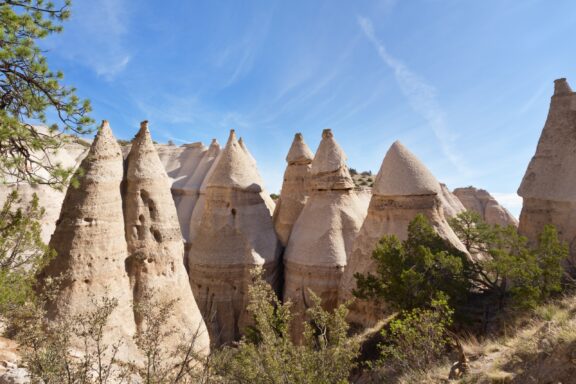 Several light-colored, cone-shaped rocks catch the midday sun in Sandoval County, New Mexico.