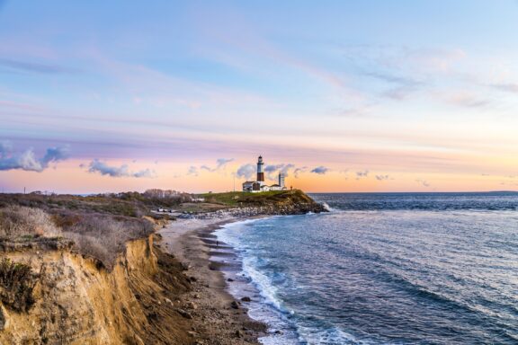 Montauk Lighthouse stands in the distance along the shore in Suffolk County.