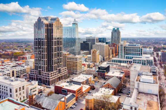 An aerial view of the Raleigh, North Carolina skyline on a sunny day.