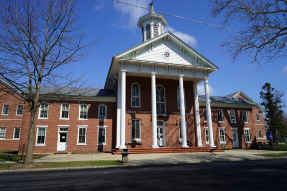 A low-angle view of the façade of the Warren County Courthouse.