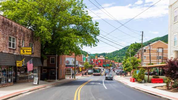 Buildings and trees line a street in the middle of Boone, North Carolina.