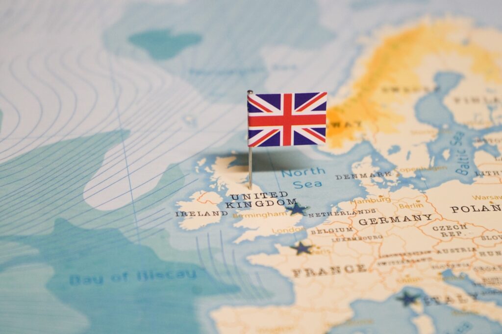 A small United Kingdom flag pin placed on a map over the UK location.