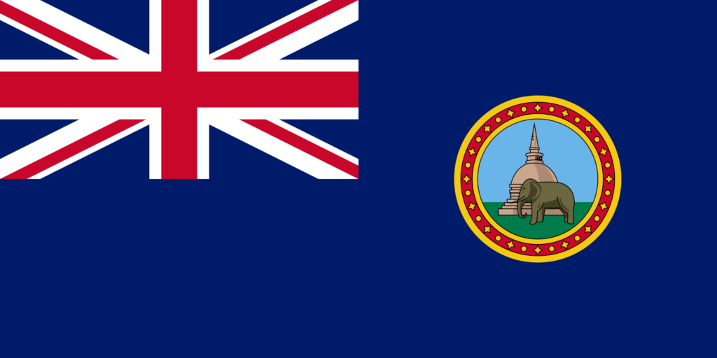 Flag of British Ceylon with a Union Jack in the corner and a crest featuring an elephant in the center.