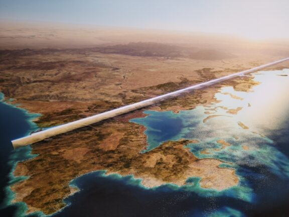 An artistic rendering of a bird’s eye view of The Line extending across Saudi Arabia as a giant, reflective silver bar.