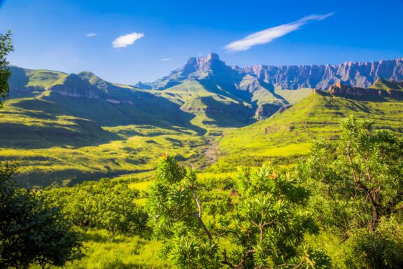 Green hills and cliffs make up the landscape in KwaZulu-Natal's Drakensberg National Park. 