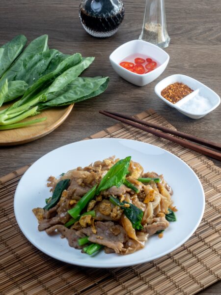 stir fried large noodles with soy sauce, dish of PAD SEE EW