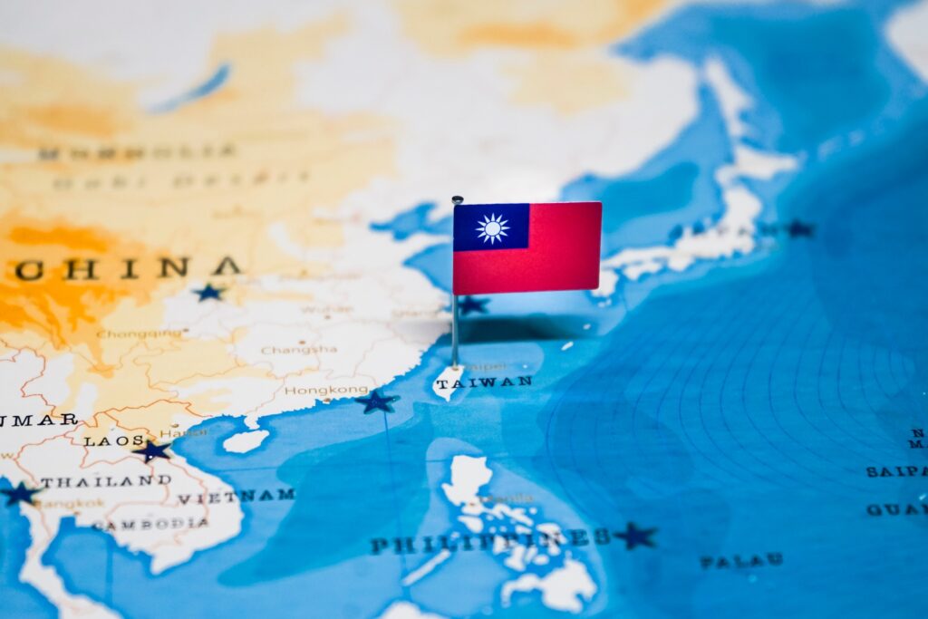 A Taiwanese flag pin placed on Taiwan on a world map.