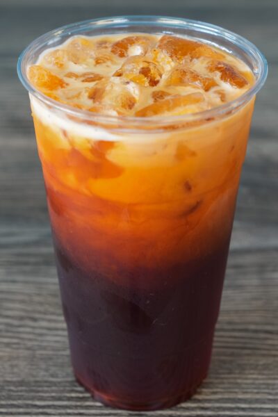 Thai ice tea on a wooden background.