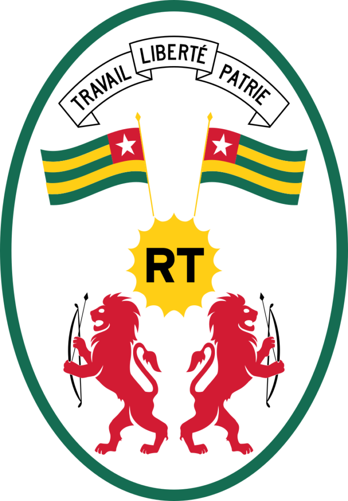 Coat of arms of Togo featuring two red lions holding bows and arrows, a gold star above 'RT' initials, and a banner with the words 'TRAVAIL LIBERTÉ PATRIE'.