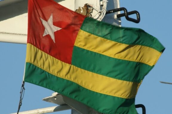 Flag of Togo fluttering on a flagpole.